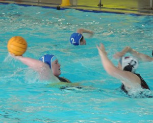 Katherine Jones (blue cap 7) in action against Cwm Draig